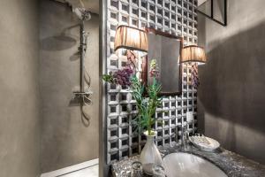 a bathroom with a sink and a mirror at Odevaere - Charming & luxurious apartment with terrace in Bruges +27 photos