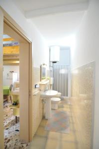 a bathroom with a toilet and a sink and a mirror at Case Vacanze Agrumi in Portopalo