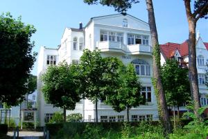 a white building with trees in front of it at Villa Frigga by Rujana in Binz