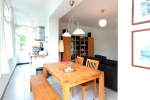 a kitchen and a living room with a wooden table at Villa Frigga by Rujana in Binz