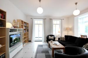 a living room with a couch and a tv at Villa Frigga by Rujana in Binz