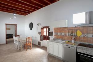 a kitchen with a table and a dining room at CASERÍO LEANDRO I in Tías