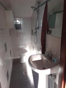 a white bathroom with a sink and a toilet at Country house near Florence in Florence