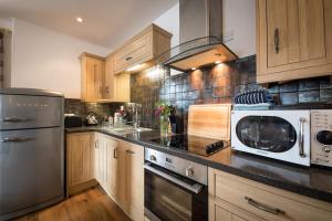 a kitchen with a microwave and a stove top oven at Dalzie in Portree