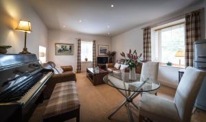 a living room with a piano and a couch at Dalzie in Portree