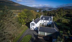 an aerial view of a large white house on a hill at Dalzie in Portree