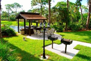 a gazebo with a table and chairs in a yard at LUX VILLAs on beautiful Palmer Ranch in Vamo