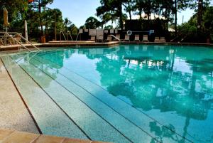 a swimming pool with blue water and a slide at LUX VILLAs on beautiful Palmer Ranch in Vamo