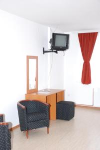 A television and/or entertainment centre at M Garni Hotel