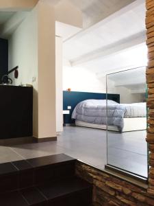 a bedroom with a bed and a glass wall at B&B Sandro Pertini in Acri