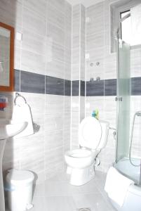 a bathroom with a toilet and a sink at M Garni Hotel in Vranje