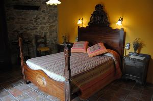 a bedroom with a large wooden bed in a room at Apartaments turistics Moli Can Coll in Campelles