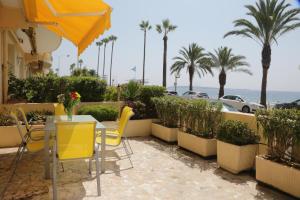a table and chairs with a view of the ocean at Plage du Midi in Cannes