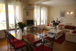 a living room with a glass table and chairs at Plage du Midi in Cannes