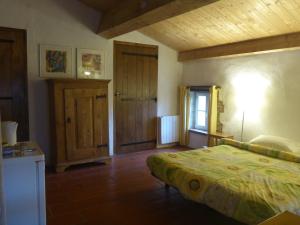 een slaapkamer met een bed, een raam en een deur bij Mas Taillet Maison d'Hôtes in Prats-de-Mollo-la-Preste