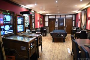 a casino with two arcade games and a pool table at L'Auberge Saint Remacle in Stavelot