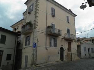 a building with plants on the balconies on a street at Ad Palatium in Cori
