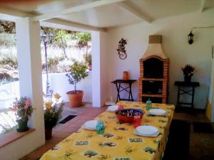 a dining room with a table with a yellow table cloth at La Carapeteria in Arronches