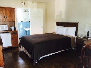 a hotel room with a bed and a sink at Brown's Motel in Aberdeen