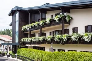 a building with plants on the balconies at Hotel Mayr in Castelrotto