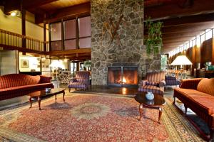 a living room filled with furniture and a fire place at Fireside Inn & Suites West Lebanon in West Lebanon