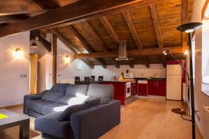 a living room with a couch and a kitchen at Aiestaenea Apartamentos Rurales in Isaba