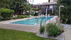 a swimming pool in the backyard of a house at Rancho Laaxdeluxe in Laax