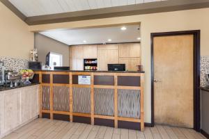 a kitchen with a bar in a room at Howard Johnson by Wyndham National City/San Diego South in National City