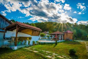a house with the sun in the sky at Complex Balkandzhii in Apriltsi