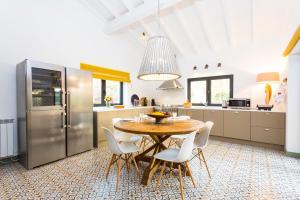a kitchen with a table and chairs and a refrigerator at Quinta do Gato, Douro Valley, Armamar in Armamar