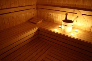 a sauna with a bucket and lights in it at Hotel Antares in Bratislava