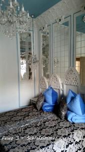 a bedroom with a bed with blue pillows at Fewo Meissen in Meißen