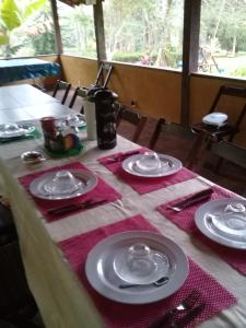 a table with plates and napkins on top of it at Sítio Canoas in Albuquerque