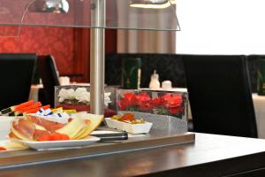 a table with plates of food on top at Hotel Herbst Berlin in Berlin