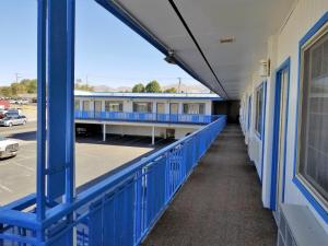 an empty hallway of a school building with blue railing at Regency Inn in Winnemucca
