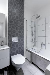 a bathroom with a shower and a toilet and a sink at ClickTheFlat Avenue Place Apart Rooms in Warsaw