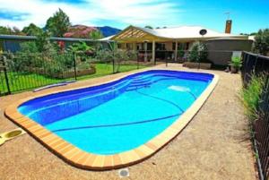 a swimming pool in the yard of a house at Yarrahapinni Homestead in Yarrahapinni