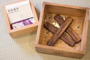 a wooden box filled with different types of chocolate at Kamoya Ryokan in Kyoto