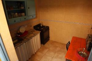 a kitchen with a sink and a stove in it at Hostel Brava mansa in Rosario