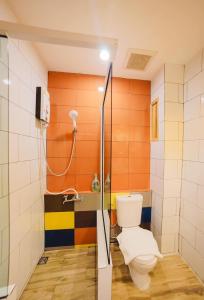 a bathroom with a toilet and a shower at Urban-Bamboo in Nakhon Ratchasima