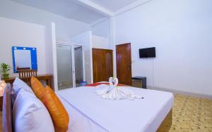 a bedroom with a bed with a towel on it at Blossoming Romduol Boutique in Siem Reap
