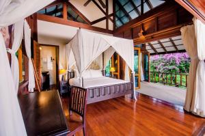 a bedroom with a bed in a room at Koh Jum Beach Villas "A member of Secret Retreats" in Ko Jum +37 photos