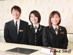 three people in suits posing for a picture at Utazu Grand Hotel in Utazu