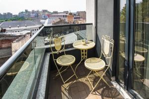 a balcony with chairs and tables on a roof at Old Town Boutique Hotel in Bucharest