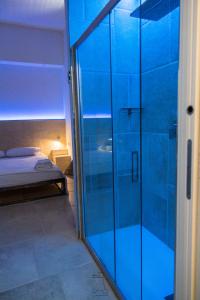 a glass shower door in a room with a bed at Casa Manfredi - Manfredi Homes&Villas in Manfredonia