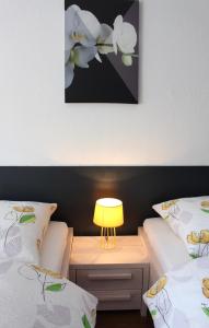 a bed room with a lamp and a lamp post at Studios near Basel Airport in Saint-Louis