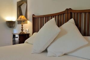 A bed or beds in a room at Petit Hotel Es Figueral