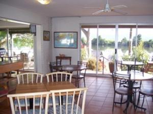 a dining room table with chairs in front of it at Tweed River Motel in Murwillumbah