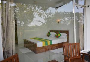 Postel nebo postele na pokoji v ubytování Kings Village Sigiriya