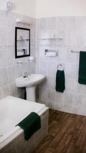 a white bathroom with a sink and a toilet and a sink at Royal Hotel Ladysmith in Ladysmith